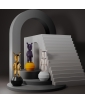 Three "the Guest" figurines  in various metallic hues.