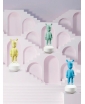 Three The Guest figurines in Yellow, mint green and blue.