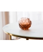 NATALI GLASS CANDLEHOLDER IN ROSALINE Color on the coffee table, Staged photo