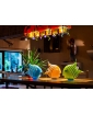 Blue, lime green, and orange Angelfish sculptures displayed on a table in a lifestyle setting.
