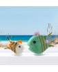 A medium mint green angelfish and a small white angelfish featured against a beach background.